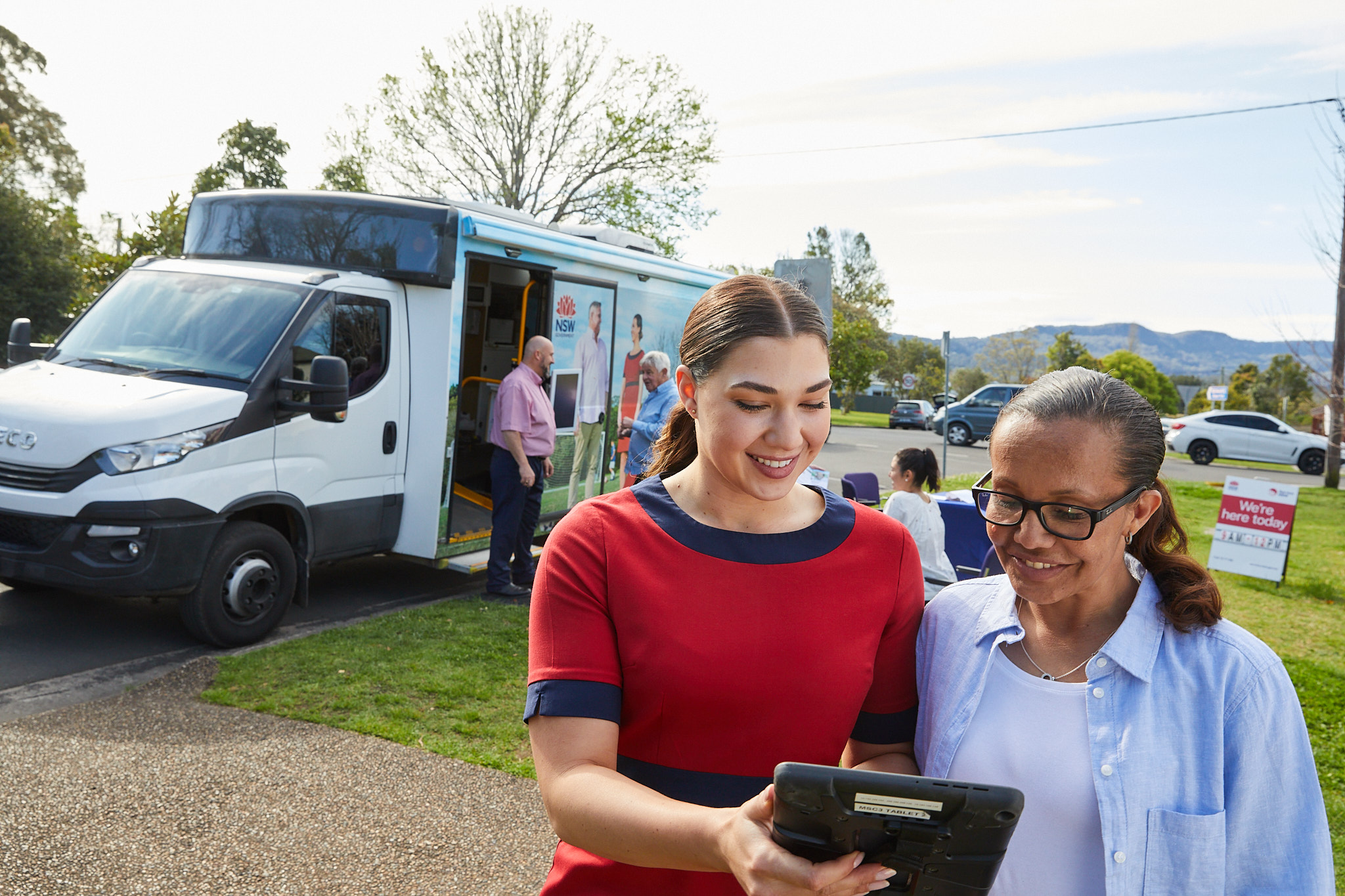 Staff at a Mobile Service Centre helping a customer