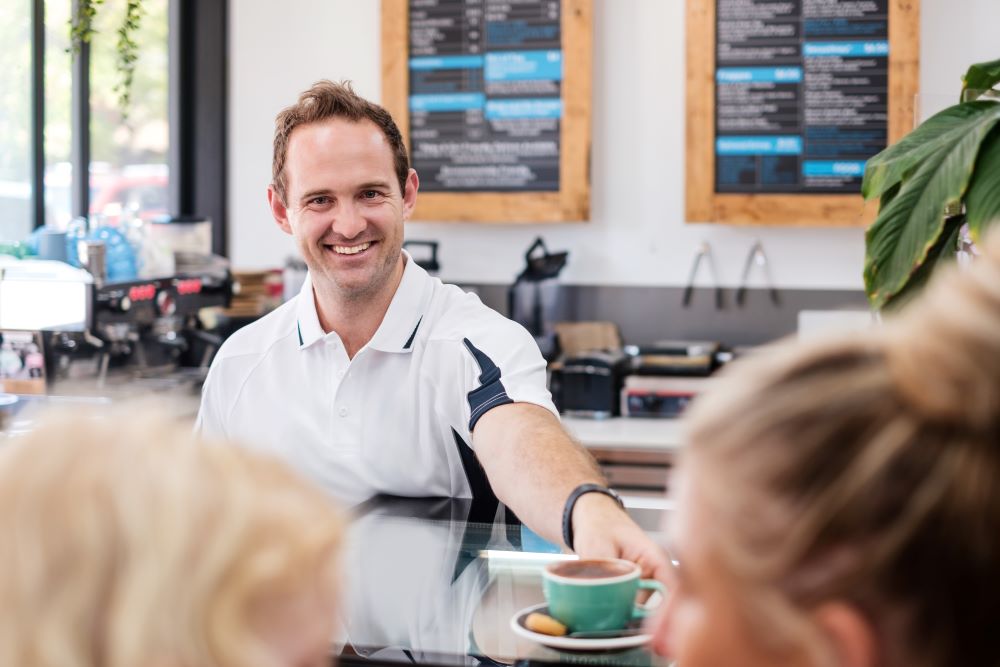 Barista serving coffee